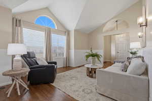 Living area featuring lofted ceiling and wood finished floors