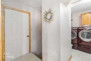 Laundry area with independent washer and dryer and cabinet space
