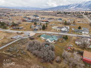 Aerial overview of property's location featuring nearby suburban area and a mountainous background