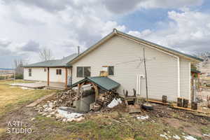 Rear view of house with a deck and a metal roof