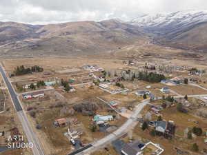 Aerial view of property and surrounding area with a mountain backdrop