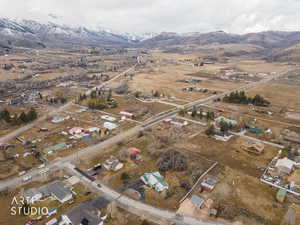 Aerial overview of property's location featuring mountains and nearby suburban area