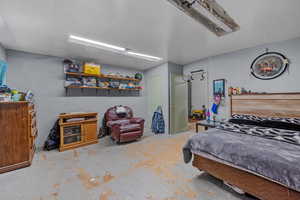 Bedroom featuring concrete flooring