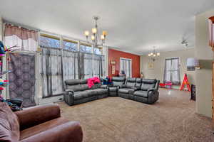 Carpeted living room with hanging lights