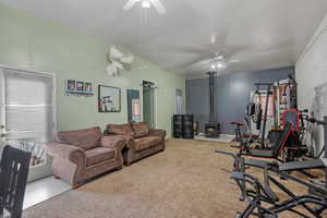 Exercise area featuring a ceiling fan and carpet