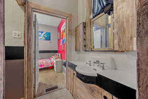 Bathroom with light carpet, vanity, and a garden tub