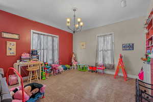 Playroom with carpet flooring and a chandelier