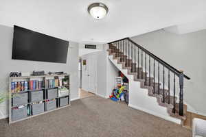 Rec room featuring carpet and a textured ceiling
