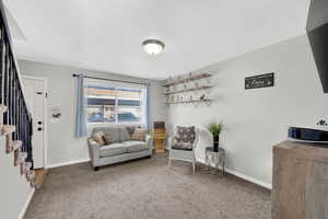 Sitting room featuring carpet flooring and a textured ceiling
