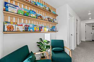 Loft area with carpet flooring and a textured ceiling
