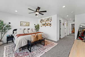 Bedroom with recessed lighting, carpet flooring, a ceiling fan, and a textured ceiling