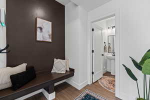 Mudroom with wood finished floors and baseboards
