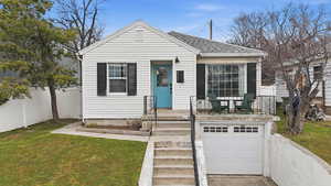 View of front of property with a shingled roof, an attached garage, and driveway