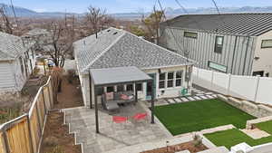 Rear view of property featuring a fenced backyard and a mountain view