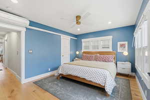 Bedroom featuring light wood-type flooring, recessed lighting, ceiling fan, a closet, and radiator