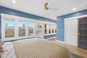 Unfurnished bedroom featuring light wood-style floors, access to outside, a ceiling fan, recessed lighting, and a closet