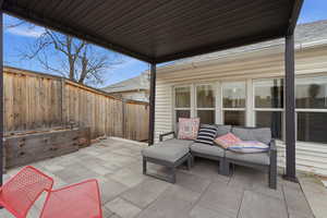 Fenced backyard with a patio and an outdoor lounge area
