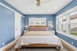 Bedroom with wood finished floors, ceiling fan, and recessed lighting