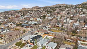 Aerial view of property's location with nearby suburban area and mountains