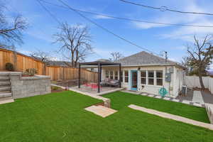 Back of property with roof with shingles, a fenced backyard, a patio area, and outdoor furniture