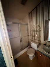 Full bath with a shower stall and vanity