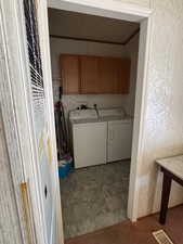 Laundry area with cabinet space, a heating unit, and separate washer and dryer