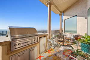View of patio / terrace with exterior kitchen and a water view