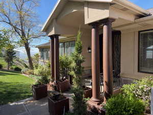 Porch featuring a lawn