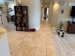 Hallway with arched walkways and ornamental molding