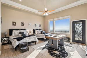 Bedroom featuring crown molding, ceiling fan, access to exterior, and light wood-type flooring