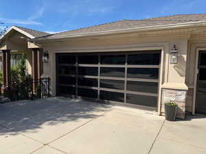 Garage featuring concrete driveway
