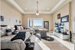 Bedroom with light wood-style floors, ceiling fan, and recessed lighting