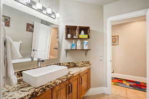 Bathroom with vanity and light tile patterned flooring