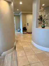 Corridor with recessed lighting and ornamental molding