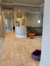 Hall featuring crown molding, recessed lighting, and an upstairs landing