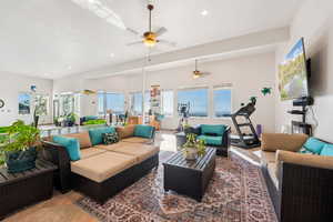 Living area with light tile patterned floors, ceiling fan, and recessed lighting