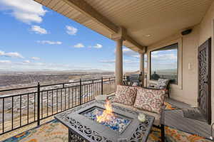 Balcony featuring a mountain view, grilling area, and an outdoor living space with a fire pit