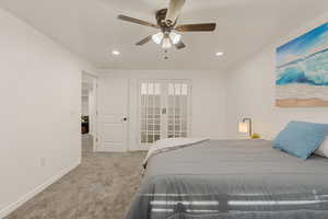 Bedroom featuring light carpet, a ceiling fan, recessed lighting, and french doors