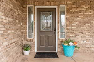 Doorway to property with brick siding