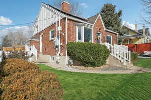 View of home's exterior with a chimney and brick siding
