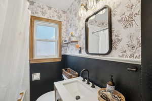 Bathroom featuring vanity and hanging lights