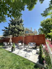 Fenced backyard with a patio and outdoor lounge area