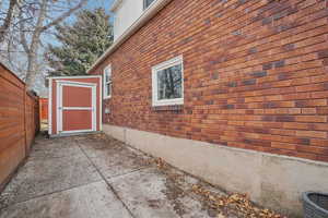 View of home's exterior with a shed and brick siding