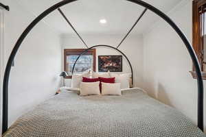 Bedroom with crown molding and recessed lighting