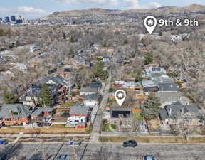 Aerial view of property's location with a mountainous background and nearby suburban area