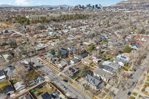 Aerial overview of property's location with a mountainous background and nearby suburban area