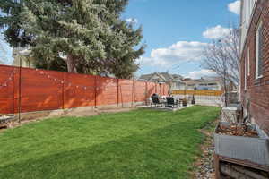 Fenced backyard with a patio area