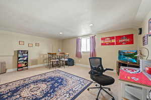 Office area with carpet, vaulted ceiling, and recessed lighting