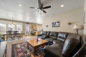 Living area featuring ceiling fan, a chandelier, and a textured ceiling