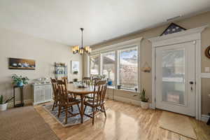 Dining space featuring light wood-type flooring and suspended lighting